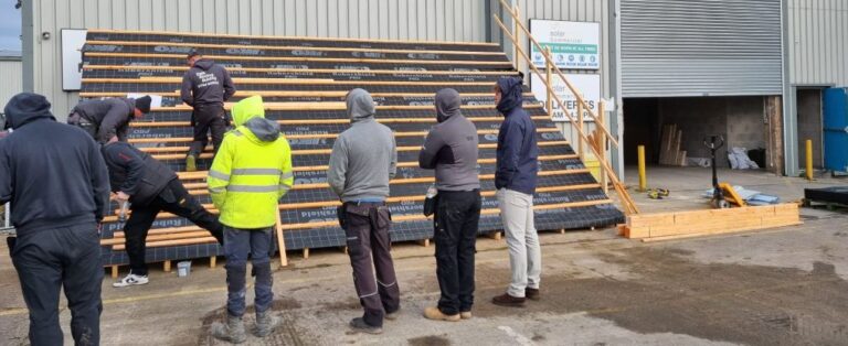 Roofers being trained on in-roof solar panel installation